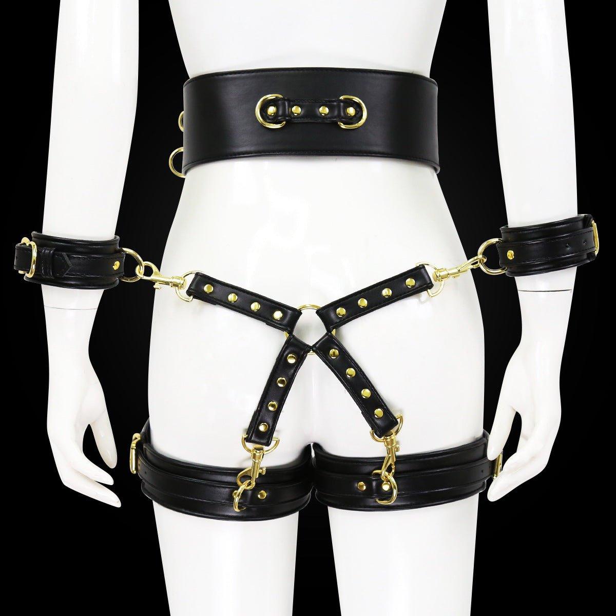 Black BDSM bondage leg cuffs set with gold accents