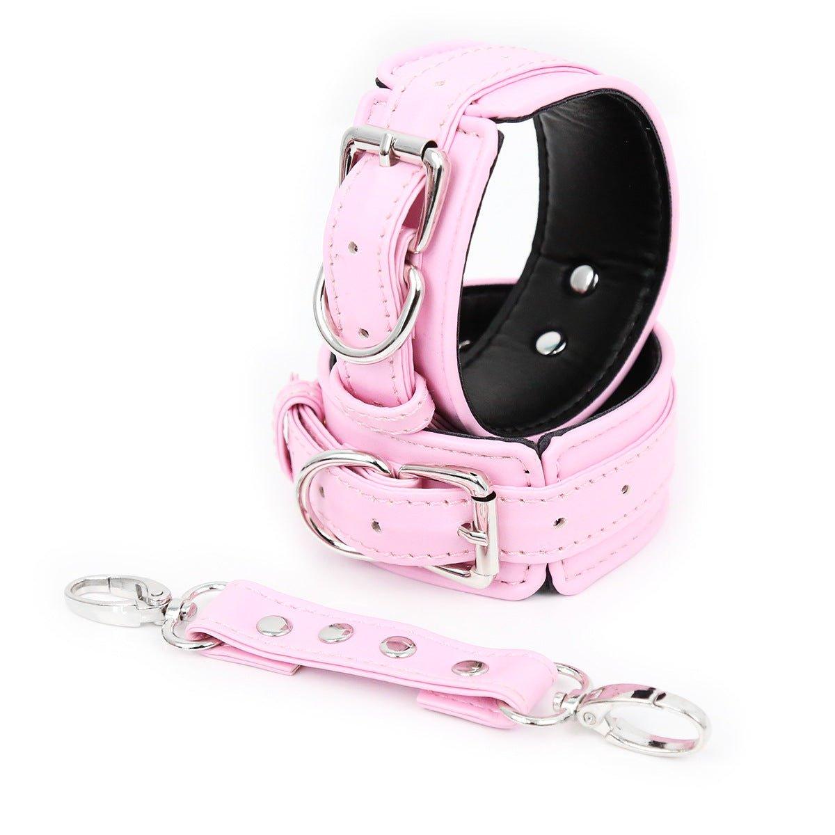 Pink faux leather hand cuffs with silver buckles