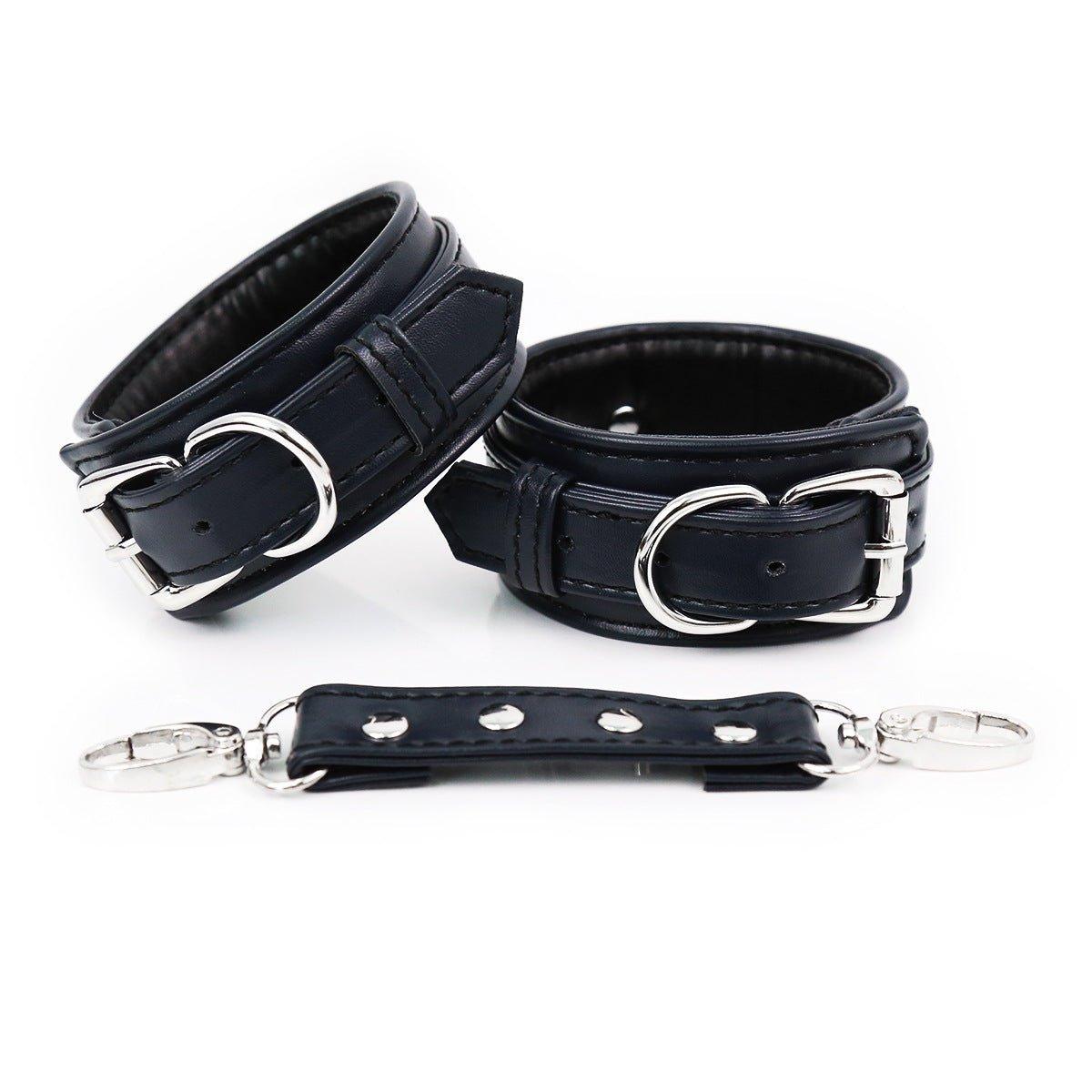 Black faux leather hand cuffs with silver buckles