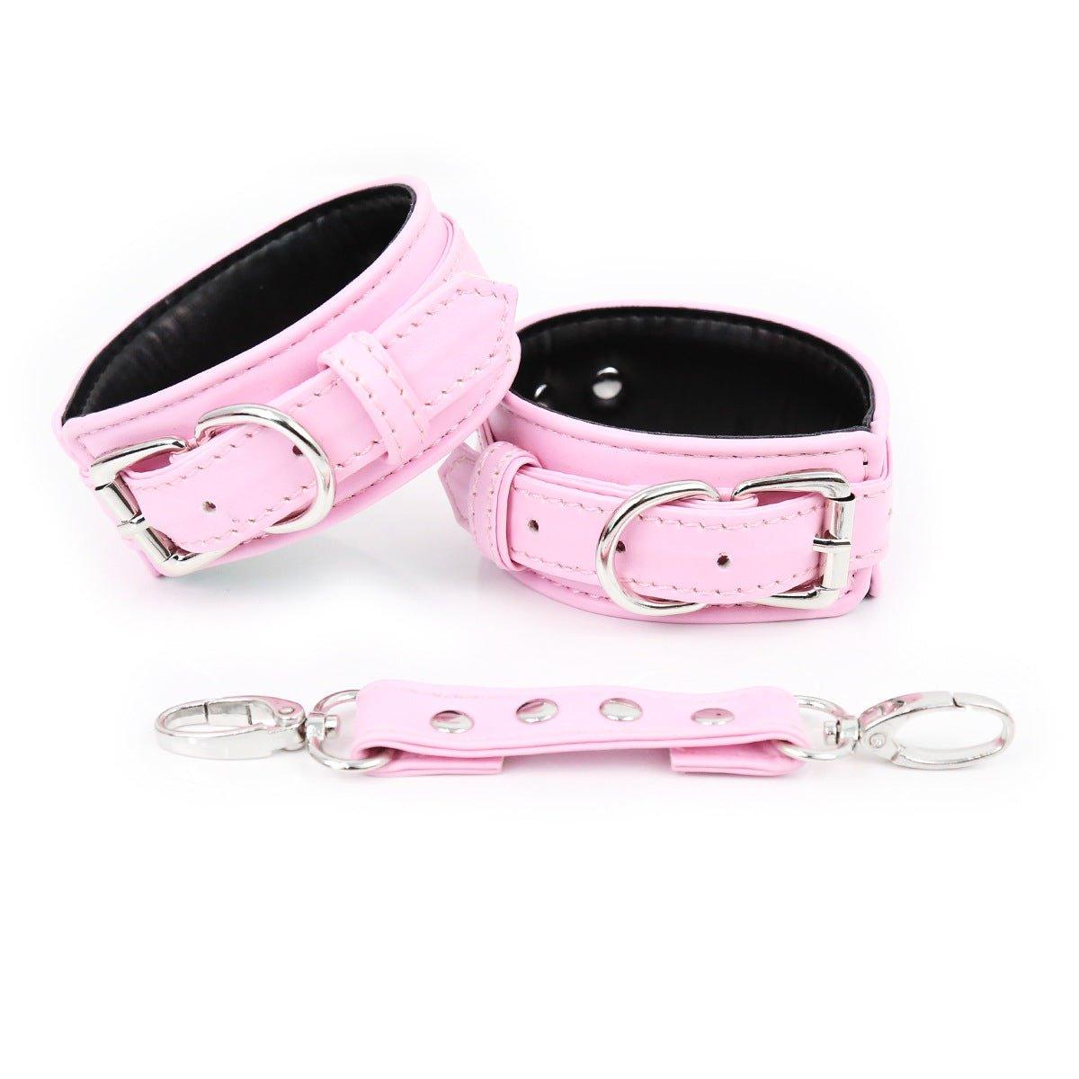 Pink faux leather hand cuffs with silver buckles