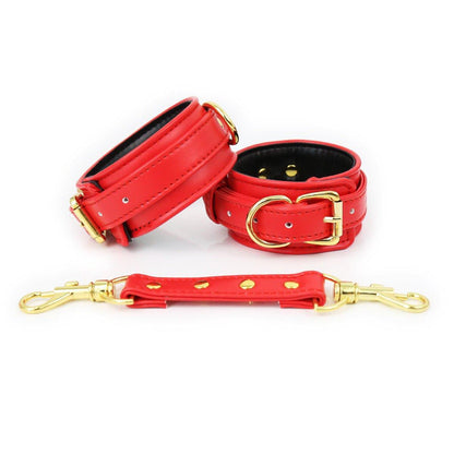 Red faux leather hand cuffs with gold buckles