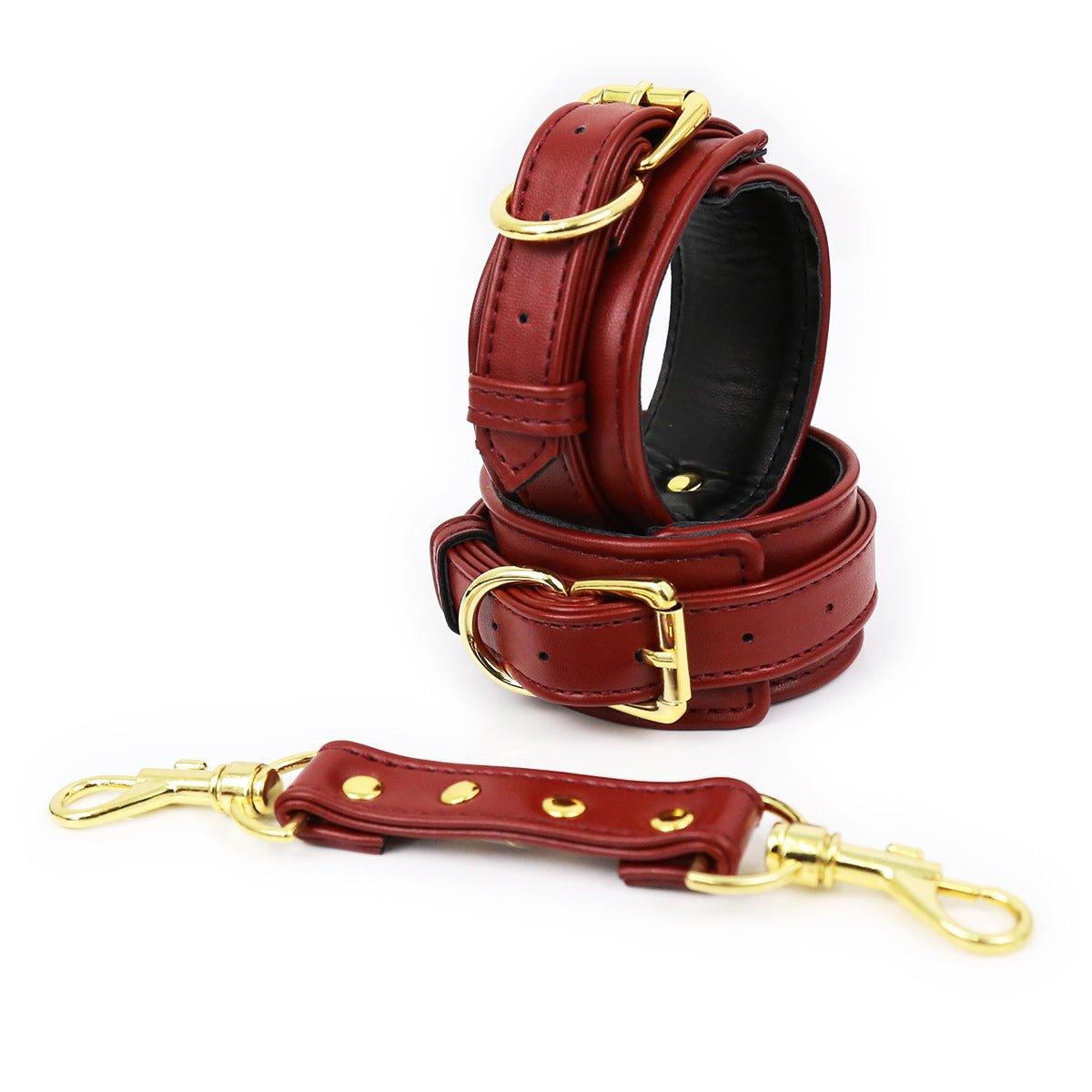 Red faux leather hand cuffs with gold buckles