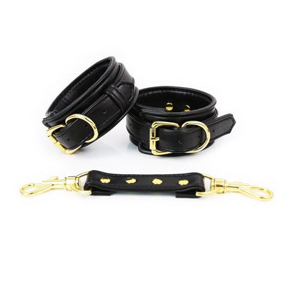 Black faux leather hand cuffs with gold buckles