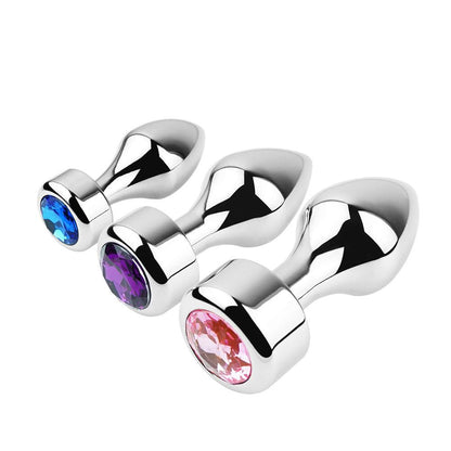 Set of three metal butt plugs with colorful gems