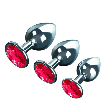 Metal butt plug kit with red gems, angled view, sizes S, M, L