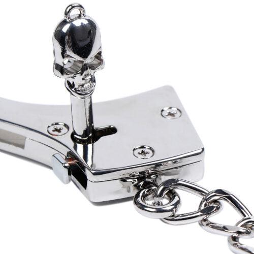 Close-up of skull key in silver handcuff lock