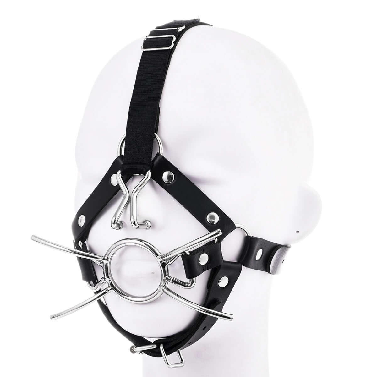 Mouth gag with nose hook harness for intense domination and restraint on a mannequin head.