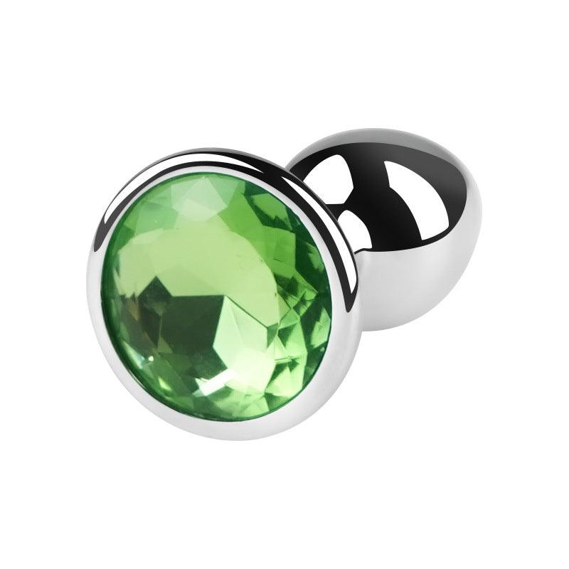 Silver metal butt plug with green gem, 2.5 inches