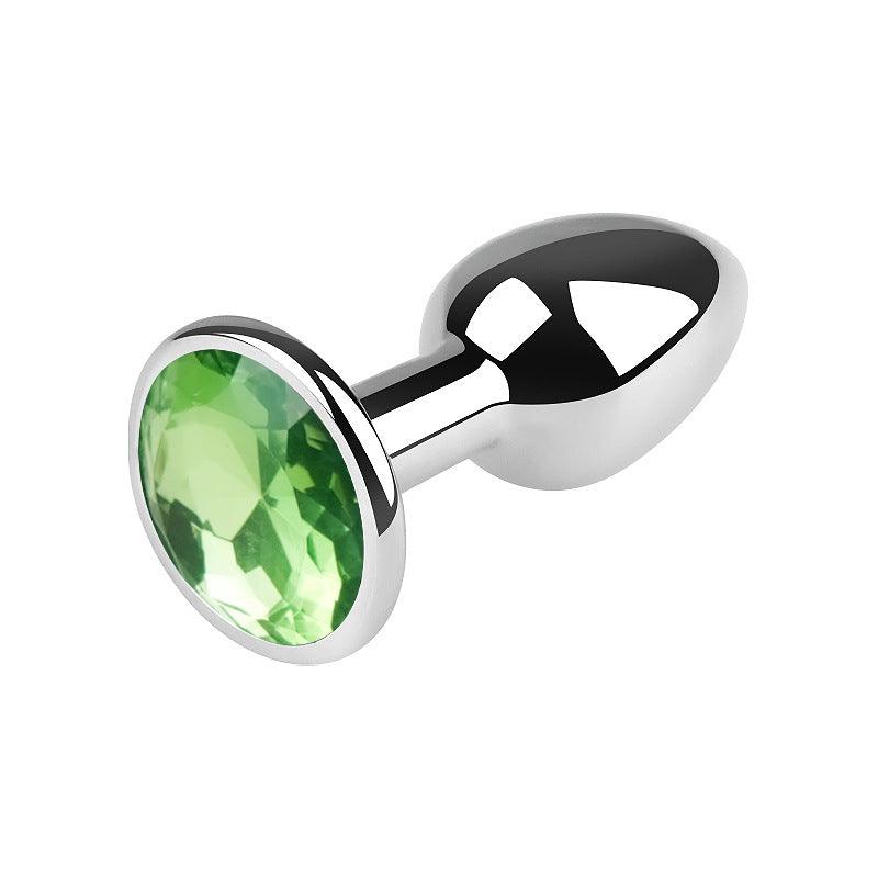 Silver metal butt plug with green gem, 2.5 inches